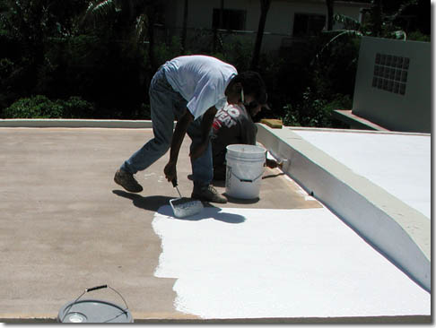 Roofer applying roof coating in Eliz City, NC